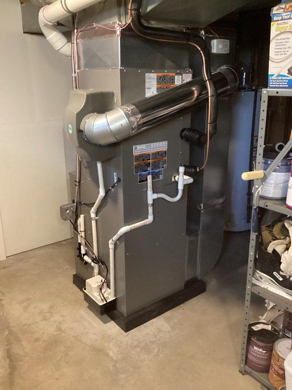 Completed full HVAC system installation including a 90,000 BTU furnace and 3-ton air conditioning unit in basement location. Installation included proper refrigerant line routing with copper piping, white PVC condensate drainage system, venting configuration, humidifier integration, and reconnection of all necessary utilities. All equipment mounted on appropriate base pad, permits obtained, mechanical components properly secured, and system tested for operational functionality per manufacturer specifications.