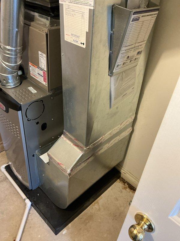 Completed installation of 70,000 BTU Lennox furnace unit in utility room. Reconnected all necessary ductwork, installed PVC venting system, and positioned unit on protective drain pan. All mechanical connections, electrical hookups, and safety controls were properly installed and tested to ensure proper operation per manufacturer specifications and local code requirements.