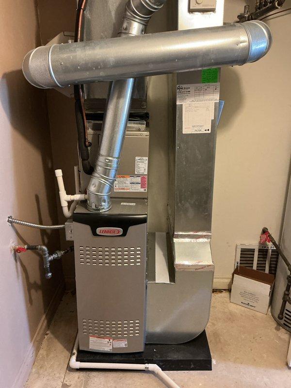 Completed installation of 70,000 BTU Lennox furnace unit in utility room. Reconnected all necessary ductwork, installed PVC venting system, and positioned unit on protective drain pan. All mechanical connections, electrical hookups, and safety controls were properly installed and tested to ensure proper operation per manufacturer specifications and local code requirements.