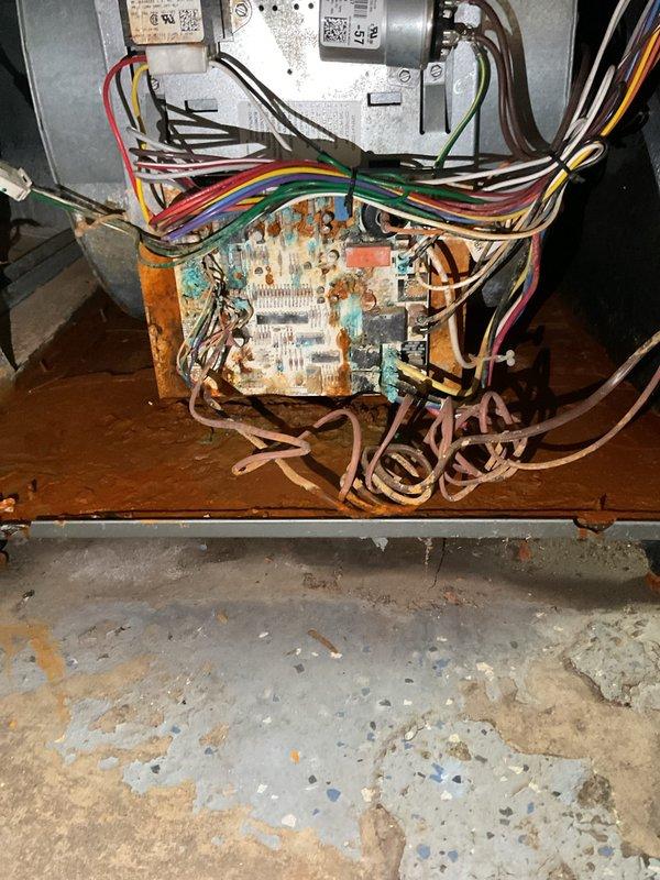 Responded to no heat call on 2018 forced air furnace that failed following flood damage. Upon inspection, found electronic control board with severe water damage and corrosion throughout, rendering unit completely inoperable. Multiple electrical components on circuit board showed extensive rust and oxidation, with moisture intrusion affecting all control circuits and safety systems. Documented extensive damage with photographs for reference. Unit deemed non-functional due to catastrophic water damage to primary control board requiring replacement.