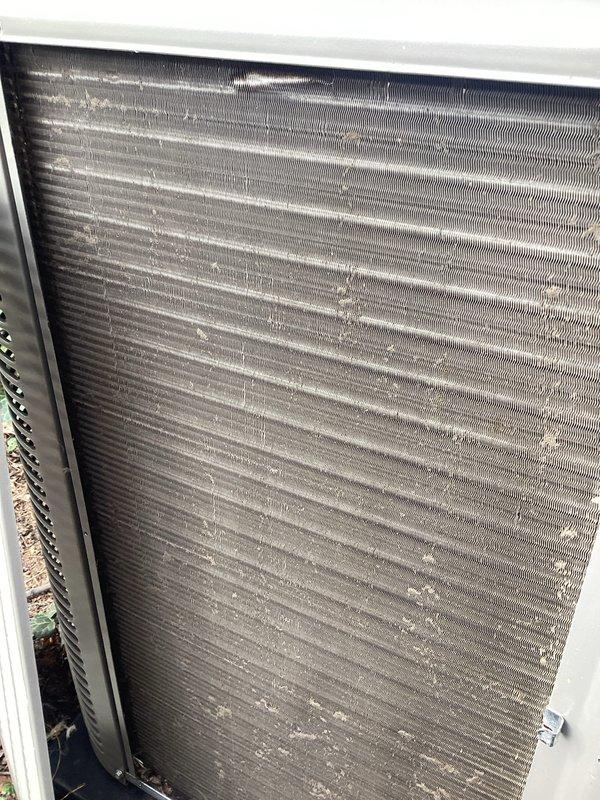 Completed routine Air Care Maintenance on residential air conditioning system. Found air filter heavily saturated with dust, dirt, and organic debris including leaves and twigs, causing significant airflow restriction. Inspected condenser coil and identified substantial accumulation of dirt, dust, and environmental contaminants across fin surfaces, with concentrated buildup in middle and lower sections reducing heat transfer efficiency. Documented equipment condition with photos showing both filter and coil contamination levels prior to service completion.