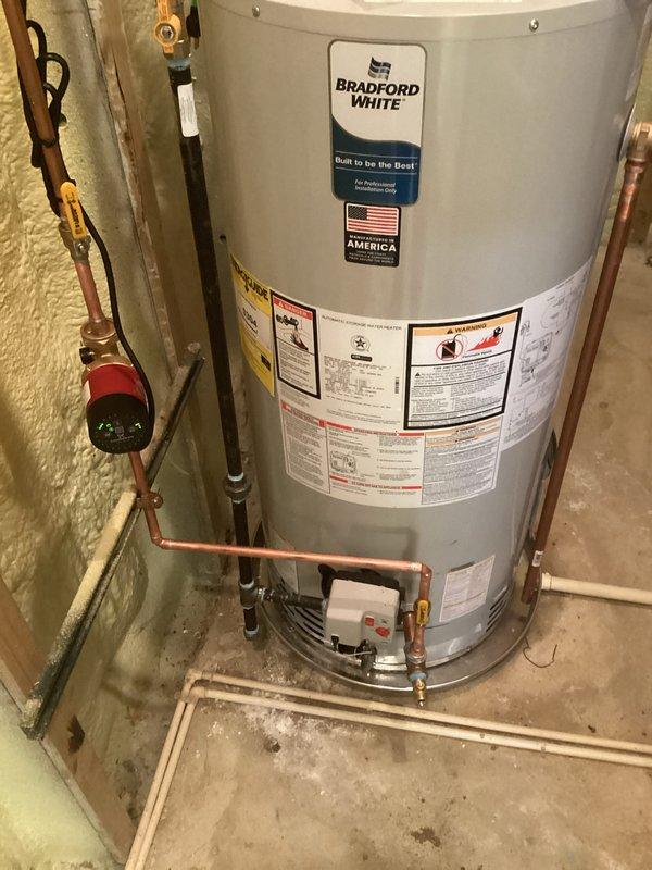Installed a new 50-gallon Bradford White tanked water heater with complete plumbing connections including copper supply and discharge piping. Installation included a Grundfos Comfort TGT recirculation pump with digital controls and status indicators, ball valves for system isolation, pressure relief valve, and proper electrical connections. All mechanical permits were obtained prior to installation, and the system was tested and verified operational upon completion.