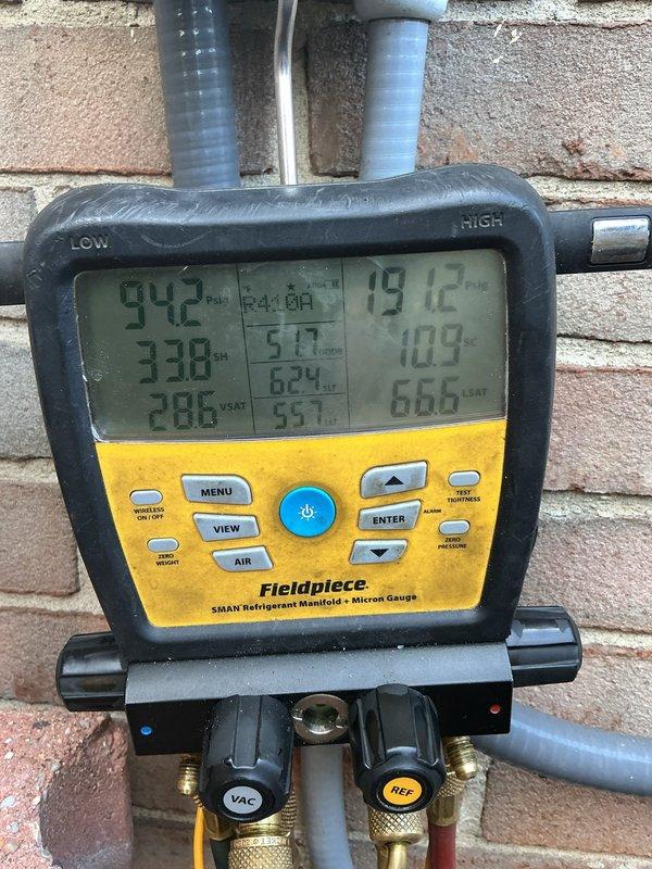 # HVAC Maintenance - ACM Completed

Performed annual cooling maintenance on Lennox outdoor condensing unit per service agreement. Conducted comprehensive system diagnostics using Fieldpiece SMAN refrigeration manifold with micron gauge capability. Measured and recorded refrigerant pressures and temperatures across the system, verifying proper operating parameters. Low side pressure reading of 94.2 PSI and high side pressure reading of 191.2 PSI indicated normal system operation. Superheat measured at 33.8°F and subcooling at 51.7°F, both within manufacturer specifications for ambient conditions.

Inspected exterior cabinet and noted biological growth (algae/mold) accumulation on top panel and upper corners of unit. Observed varying degrees of panel weathering and discoloration from environmental exposure. Unit positioned on concrete pad with adequate clearance, though surrounded by mulch and organic debris. Verified all electrical connections secure and operational. System operating ef