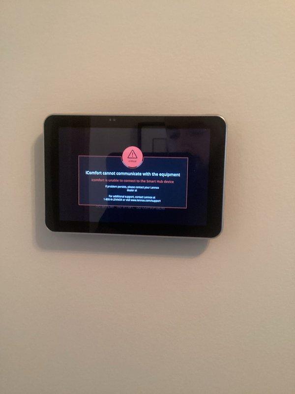 Responded to service call for Lennox iComfort thermostat displaying communication error with HVAC equipment. Upon arrival, confirmed thermostat was unable to establish connection with Smart Hub and heating system located in basement. Troubleshot communication failure between wall-mounted iComfort control panel and equipment, verified thermostat was powered and displaying proper temperature readings of 69°F with heat setpoint at 67°F. Diagnosed connectivity issue between thermostat and Smart Hub device, restored communication protocol, and verified system operation. Confirmed heating system responding properly to thermostat commands and all functions operating as designed. System tested and left in working order with both parts and labor under warranty coverage.