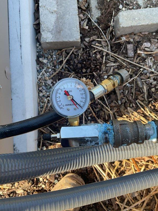 Performed pressure test on commercial generator gas line installation using calibrated gauge equipment. Test assembly was connected to the blue service valve manifold at the building exterior, with gauge readings monitored to verify system integrity and confirm proper installation per code requirements. All connections held pressure within acceptable parameters, validating the gas line installation for safe generator operation.