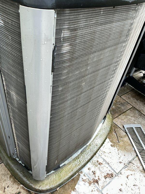 Completed annual cooling maintenance on outdoor HVAC system. Inspected evaporator coils, heat exchanger fins, copper refrigerant lines, and condenser unit, noting accumulation of dirt and debris on corrugated metal surfaces and oxidation on copper piping from weather exposure. Unit operational with normal signs of outdoor weathering; concrete pad showed algae growth and debris requiring routine cleanup.