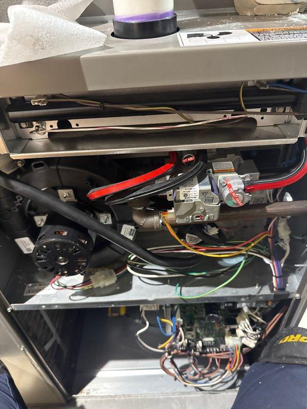 Completed annual heating check on residential air conditioning unit. Removed access panels to inspect internal components including blower motor assembly, gas valve connections, electrical wiring, control board, and safety interlock mechanisms. All components were visually inspected and found to be in proper working condition with no signs of damage or deterioration.