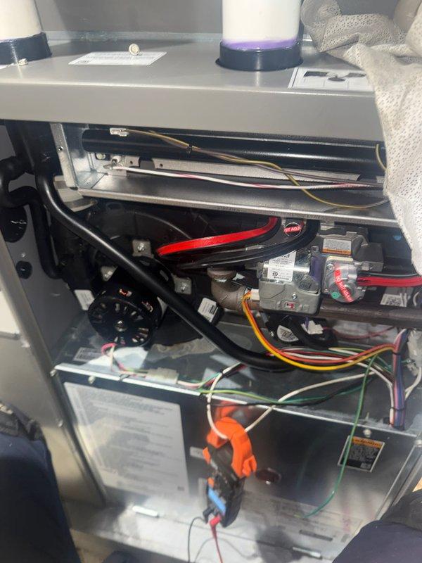 Completed annual heating check on residential air conditioning unit. Removed access panels to inspect internal components including blower motor assembly, gas valve connections, electrical wiring, control board, and safety interlock mechanisms. All components were visually inspected and found to be in proper working condition with no signs of damage or deterioration.