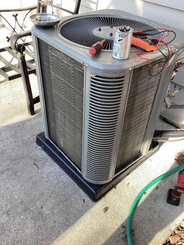 Completed annual furnace maintenance tune-up as part of membership program on a brand new furnace system (0 years old). Performed comprehensive inspection and servicing of the heating unit, ensuring all components were operating within manufacturer specifications. During the service visit, also inspected the outdoor air conditioning condenser unit positioned on the rooftop, which showed normal operating condition with proper clearances and ventilation. Verified capacitor functionality (40/5 MFD dual capacitor observed during inspection), checked electrical connections, and confirmed the condensing unit was properly secured on its pad. Cleaned debris including leaves from around both the rooftop condenser unit and ground-level equipment areas to ensure proper airflow and system efficiency. All safety controls tested and verified operational on both heating and cooling systems.