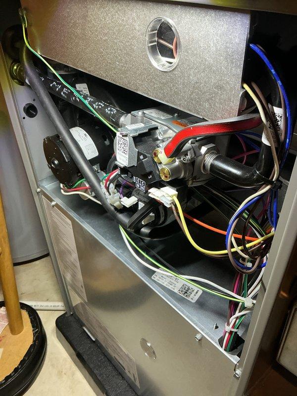 Completed annual heating check on residential HVAC system. Removed access panel and performed comprehensive inspection of all internal components including gas valve assembly, blower motor, electrical connections, and control module. Verified proper wire connections across all colored wire runs, inspected refrigerant lines and tubing for integrity, and confirmed all mechanical components were securely mounted and functioning within normal parameters. System tested and operating efficiently with no issues found.