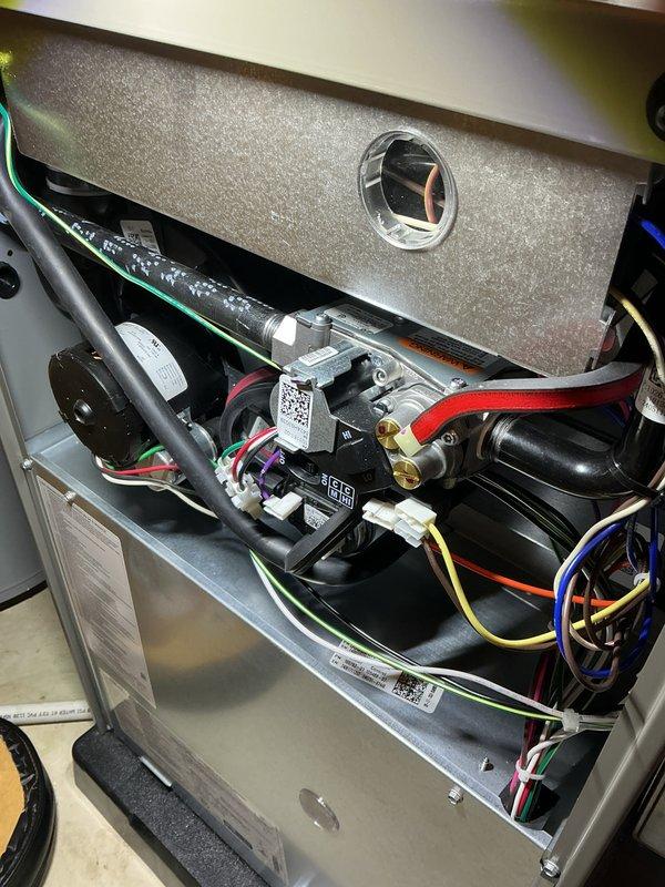 Completed annual heating check on residential HVAC system. Removed access panel and performed comprehensive inspection of all internal components including gas valve assembly, blower motor, electrical connections, and control module. Verified proper wire connections across all colored wire runs, inspected refrigerant lines and tubing for integrity, and confirmed all mechanical components were securely mounted and functioning within normal parameters. System tested and operating efficiently with no issues found.