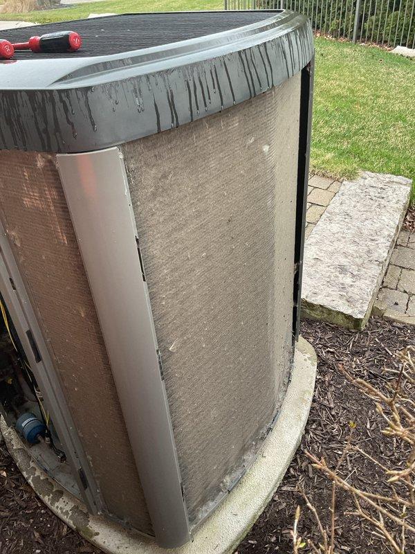 Completed annual cooling maintenance on residential air conditioning system. Inspected outdoor condenser unit, noting visible dirt accumulation and staining on cabinet exterior from environmental exposure and water runoff. Unit operational and positioned properly on concrete pad with adequate clearance for airflow.