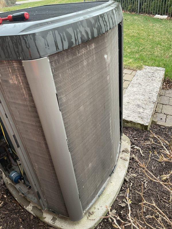 Completed annual cooling maintenance on residential air conditioning system. Inspected outdoor condenser unit, noting visible dirt accumulation and staining on cabinet exterior from environmental exposure and water runoff. Unit operational and positioned properly on concrete pad with adequate clearance for airflow.