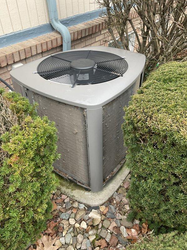 Completed annual cooling maintenance on residential air conditioning system. Inspected outdoor condenser unit, cleared accumulated leaves and debris from beneath protective grating, and verified proper airflow through louvered panels. Documented equipment condition with photos and recommended return appointment for heating maintenance in fall season.