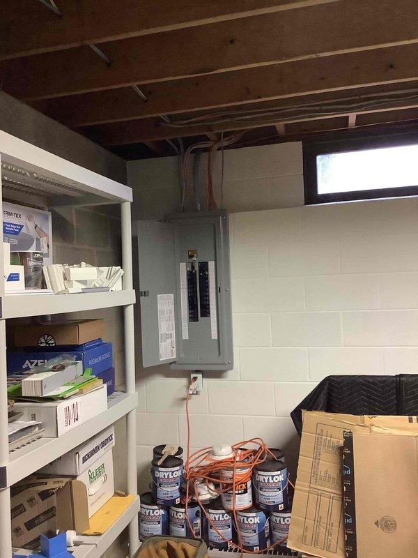 Conducted on-site assessment for new Generac generator installation at residential property. Evaluated existing electrical infrastructure, including main service panel location in basement and available space for generator placement. Documented current electrical system configuration, mechanical room layout, and utility connections to determine optimal generator sizing and installation requirements. Photographed electrical panel, HVAC equipment, water heater, and basement utility area to assess clearances, ventilation needs, and transfer switch mounting location. Identified 30-year-old home with standard residential electrical service requiring integration of automatic transfer switch with existing distribution panel. Reviewed available pathways for gas line connection, electrical conduit routing, and exterior generator pad placement to prepare comprehensive installation estimate.