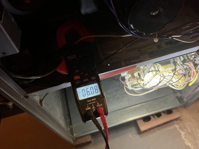 Completed annual cooling maintenance on HVAC system, performing comprehensive inspection and testing of all components. Verified electrical measurements using multimeter, reading 0.608 on control circuits, and inspected blower wheel assembly and motor operation. All system components found operating within normal parameters with no deficiencies noted.