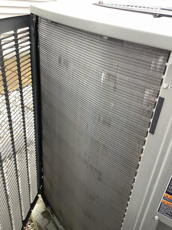 Completed spring air conditioning tune-up on 10-year-old Goodman system. Performed comprehensive diagnostic testing using digital manifold gauges, confirming R410A refrigerant charge with suction pressure at 104.0 psi and discharge pressure at 251.5 psi. Superheat measured 15.5°F and subcooling measured 13.5°F, both within manufacturer specifications. System temperatures showed proper operation with 21.6°F temperature split across evaporator coil. Inspected outdoor condenser unit and noted moderate dust accumulation on coil fins. System confirmed operating properly with all readings nominal for current conditions.