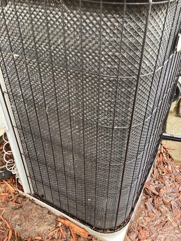 Completed annual preventive maintenance on residential air conditioning system. Unit inspected and found in operational condition with protective grille intact and secure. Observed debris accumulation around base of condenser unit; no filter replacement required per service specifications.