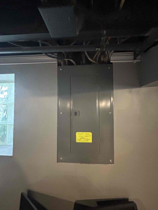 Responded to assess storm-damaged AC condensing unit in basement after tree branch impact. Found older high-efficiency Rheem unit rotated approximately 30 degrees from original installation position with compromised structural integrity. Documented extensive damage including bent hail guard frame, torn fan mounting strut support, and one completely cracked/broken fan mounting strut. Determined refrigerant brazing lines have been compromised due to forced angular displacement, creating safety concerns and potential for refrigerant leaks with further movement. Fan assembly deemed unsafe for operation due to damaged mounting frame presenting risk of catastrophic motor and blade failure. Recommended safe refrigerant recovery prior to any further disturbance and advised against repair attempts due to extent of structural damage. Provided estimate for complete system replacement.