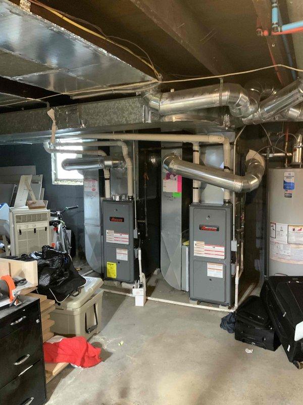Completed site assessment for residential property requiring installation of two new air conditioning units where no existing AC system is present. Evaluated basement mechanical room containing two existing furnace units with ductwork infrastructure and determined feasibility for dual AC system integration. Documented existing HVAC equipment configuration, available space for outdoor condenser placement, and measured installation areas to verify equipment clearances and accessibility for expedited installation timeline.