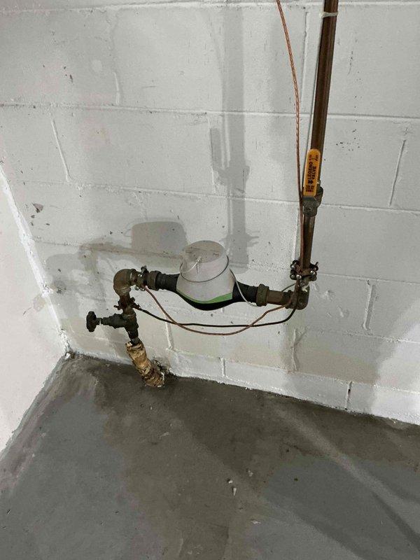 Completed sales estimate for new Mitsubishi mini split system installation to replace existing R22 air handler system. Assessment included evaluation of current electrical service capacity at exterior meter location and inspection of existing basement ductwork requiring replacement. Documented existing utility connections, HVAC equipment placement area, and basement plumbing infrastructure to determine optimal routing for new refrigerant lines and condensate drainage.