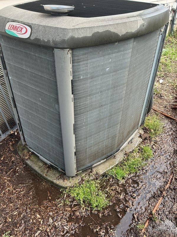Completed annual cooling maintenance on Lennox air conditioning condenser unit. Inspected outdoor unit which showed significant fin damage, bent louvers, and debris accumulation around base and coil surfaces. Cleaned condenser coils, removed leaves and organic matter from unit base and surrounding area, and replaced air filters per maintenance protocol.