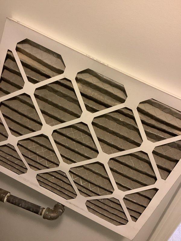 Performed routine Air Care Maintenance on cooling system. Inspected and documented return air filter condition showing normal dust accumulation through hexagonal grille openings. Tested system capacitor using clamp meter, recording 3.651 nF capacitance reading to verify component is operating within acceptable parameters for continued reliable operation.