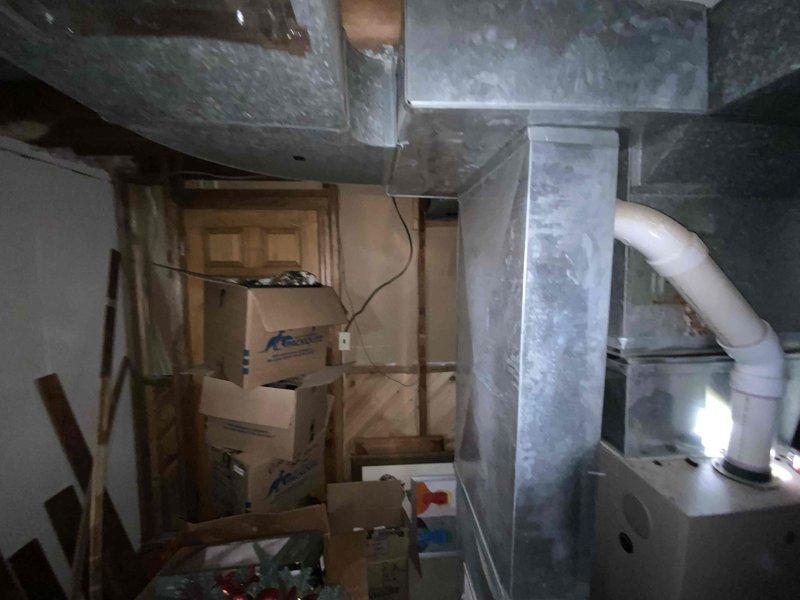 Conducted estimate for replacement of 25-year-old electric furnace and air conditioning system located in basement. Current equipment is operational but nearing end of service life with visible dust accumulation on ductwork and aging sheet metal components. Evaluated existing PVC drainage lines, ductwork configuration, and equipment accessibility in unfinished mechanical space to provide comprehensive replacement options for both heating and cooling units.