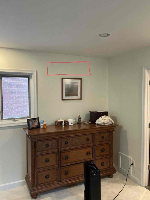 Completed estimate for mini split installation in bedroom space. Evaluated wall location above dresser for indoor unit placement, as indicated by marked installation area, and assessed electrical panel capacity to determine circuit requirements for new mini split system.