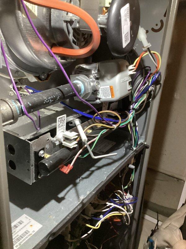 Completed routine Air Care Heating and Cooling maintenance on residential HVAC system. Inspected furnace and air handler components, verified proper operation of gas valve assembly, blower motor, and electrical connections. Identified need for MERV 8 1-inch filter replacement and documented equipment condition with photos showing internal components and system configuration.