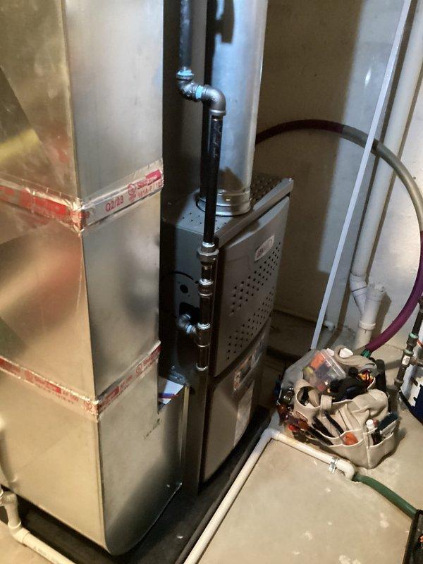 Completed routine Air Care Heating and Cooling maintenance on residential HVAC system. Inspected furnace and air handler components, verified proper operation of gas valve assembly, blower motor, and electrical connections. Identified need for MERV 8 1-inch filter replacement and documented equipment condition with photos showing internal components and system configuration.