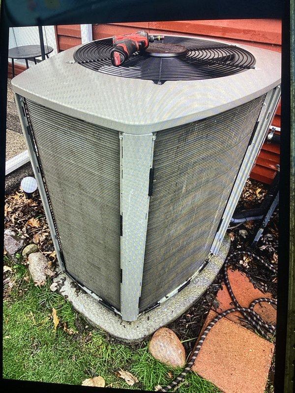 # HVAC Maintenance - ACM Service Completed

Performed routine Air Care Maintenance on residential outdoor condensing unit. Upon arrival, conducted comprehensive visual inspection of equipment exterior, noting weathered cabinet panels with typical dirt accumulation and aging consistent with normal outdoor exposure. Unit positioned on concrete pad with adequate clearance for airflow.

Completed standard ACM protocol including:

- Inspected condenser coil panels through protective grilles for debris accumulation
- Verified fan guard integrity and proper mounting
- Examined unit foundation and concrete pad for levelness and stability
- Assessed surrounding area for vegetation encroachment or drainage concerns
- Checked cabinet panels for corrosion, damage, or loose fasteners
- Documented equipment condition through photographic records

Unit operational with no immediate service concerns identified during maintenance inspection. All protective components including fan guard and cabinet pan