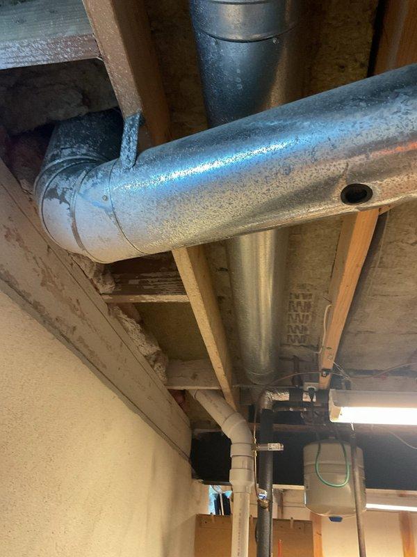 Responded to service call for loud noises coming from blower fan on 7+ year old furnace located in basement. Upon inspection, diagnosed blower motor bearing failure causing excessive noise during operation. Replaced defective blower motor assembly and verified proper airflow and quiet operation. Inspected ductwork and noted condensation present on supply ducts, which is unrelated to the blower issue but indicates potential insulation needs. System tested through multiple heating cycles with no abnormal sounds detected. Unit operating within manufacturer specifications with parts covered under warranty.