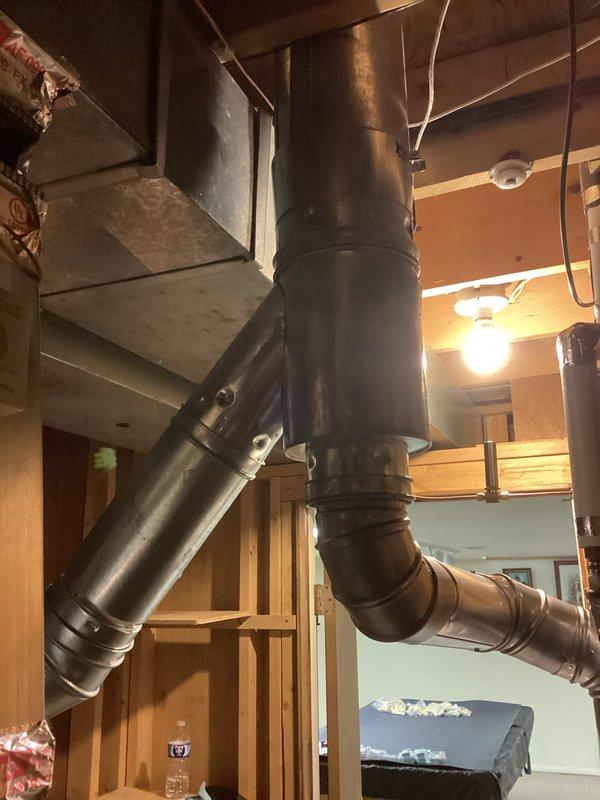 Completed full HVAC system installation including a 90,000 BTU furnace and 3-ton air conditioning unit with rear discharge configuration. Installed air handler on wooden platform in mechanical space with proper condensate drainage via PVC piping and metallic duct connections. Ran galvanized ductwork vertically through living space with branch connections to distribution system, securing all components to structural joists and beams. Completed electrical reconnection and obtained mechanical and electrical permits prior to installation. System tested and operational upon completion.