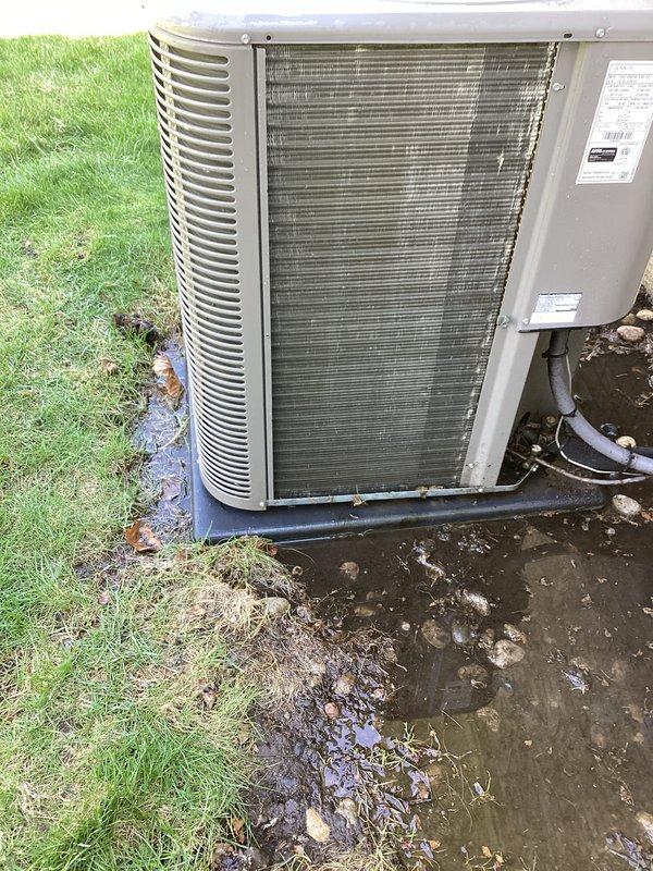 Completed annual cooling maintenance on residential outdoor condenser unit. Performed standard ACM protocol including inspection of exterior housing, louvers, and grilles, verification of proper airflow through horizontal fin assembly, and documentation of unit condition. Unit operational with normal weathering present on exterior panels; noted significant water pooling and drainage issues around concrete pad requiring customer attention to prevent future equipment concerns.