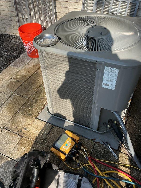 Completed comprehensive AC tune-up maintenance on residential outdoor condensing unit. Performed full system inspection, electrical diagnostics with multimeter to verify proper voltage and amperage at compressor connections, cleaned condenser coils, checked refrigerant levels, and tested fan motor operation. Unit operating within manufacturer specifications with no issues identified.