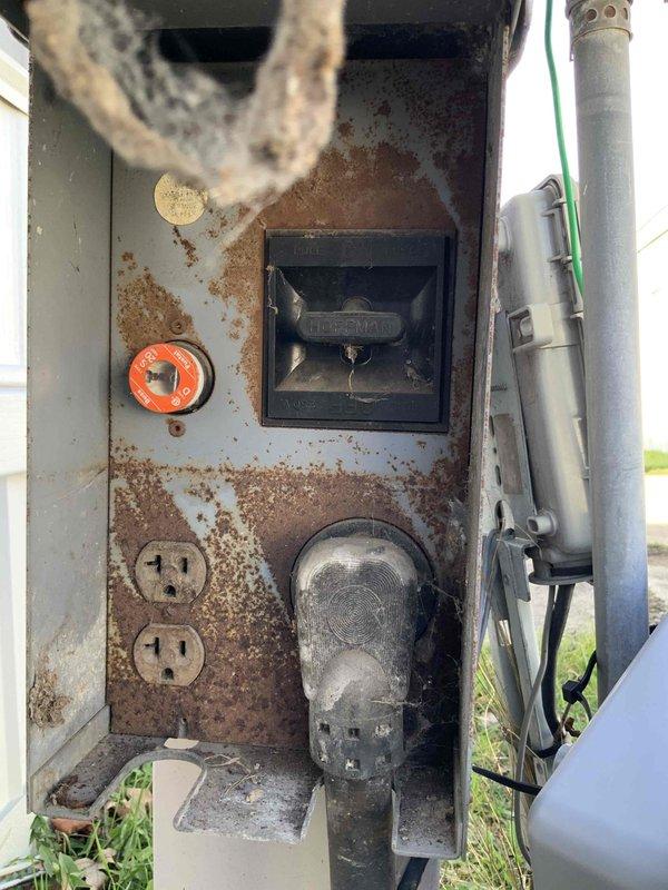 Conducted HVAC replacement estimate for mobile home with 16-year-old International Comfort rooftop AC unit experiencing thermostat communication failure. Diagnosed no voltage at thermostat while confirming proper voltage at unit, indicating damaged or disconnected stat wire requiring complete replacement run. Assessed severely corroded outdoor electrical panel and weathered utility connections serving the HVAC system. Provided estimate options for complete thermostat wire installation with additional labor requirements and discussed system replacement considerations given equipment age and existing gas furnace configuration.