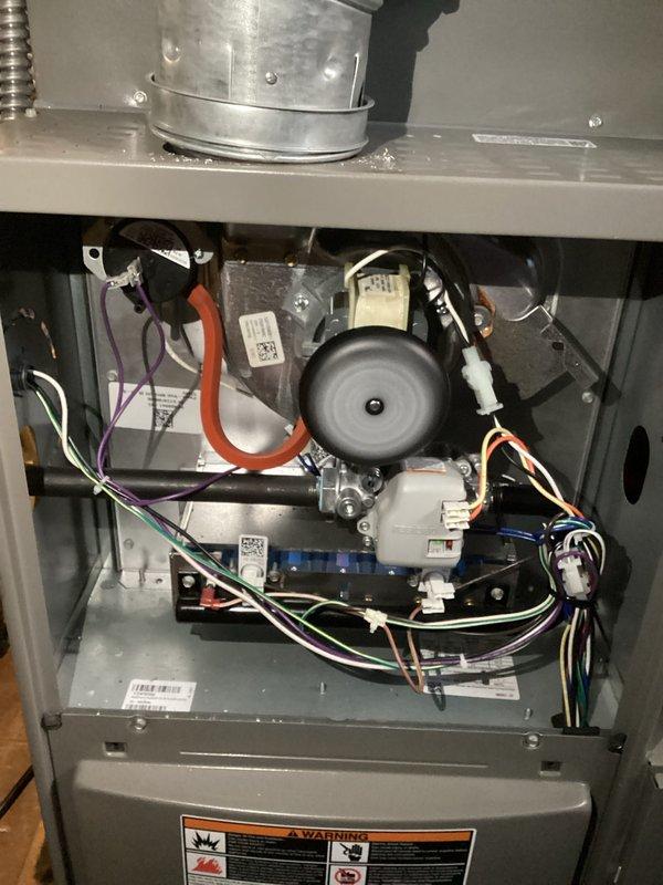 Completed annual heating maintenance on residential furnace system as part of preventative maintenance membership. Performed comprehensive tune-up inspection including visual examination of all internal components, electrical connections, and safety systems. Removed access panels to inspect inducer motor assembly, heat exchanger, control board, and wiring harnesses. Verified all wire connections secure with proper color coding intact (orange, purple, white, black, and blue conductors). Inspected draft inducer motor housing and mounting for proper operation. Examined control board module and associated electrical connections for signs of wear or damage. Confirmed all manufacturer identification labels and warning decals present and legible. Checked ductwork connections and flexible connector at plenum interface. System found to be in proper working condition with no deficiencies noted. All components operating within normal parameters. Unit ready for heating season operation.