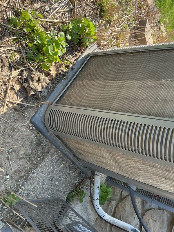 Completed routine maintenance on an 8-year-old central air conditioning system currently operating properly. Performed comprehensive AC tune-up including inspection of outdoor condensing unit, verified proper airflow through condenser coils, checked refrigerant levels, and tested electrical connections. Noted moderate accumulation of dirt and debris on condenser fins and surrounding area; cleaned coils to restore optimal heat transfer efficiency. Inspected condensate drainage system including PVC discharge lines for proper operation. All components tested within normal operating parameters, and system left in good working condition for continued reliable cooling performance.