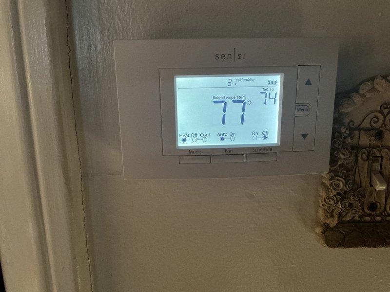 Completed complimentary annual heating maintenance and tune-up on residential furnace system per membership agreement. Performed comprehensive inspection of HVAC equipment including outdoor unit and indoor climate control system. All components operating within normal parameters with no issues identified. Thermostat displaying proper readings with room temperature at 71°F, set point at 74°F, and humidity at 37%. Outdoor unit found in clean, well-maintained condition with no visible signs of wear, damage, or deterioration. System ready for heating season operation.