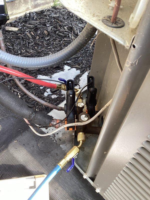 Completed annual cooling maintenance on outdoor AC unit per scheduled service call. Connected manifold gauges to service ports and performed refrigerant pressure diagnostics to verify proper system charge and operation. Inspected refrigerant line connections, copper piping, valves, and all mechanical components for proper function and potential leaks. All equipment found operating within normal parameters with no issues identified during inspection.
