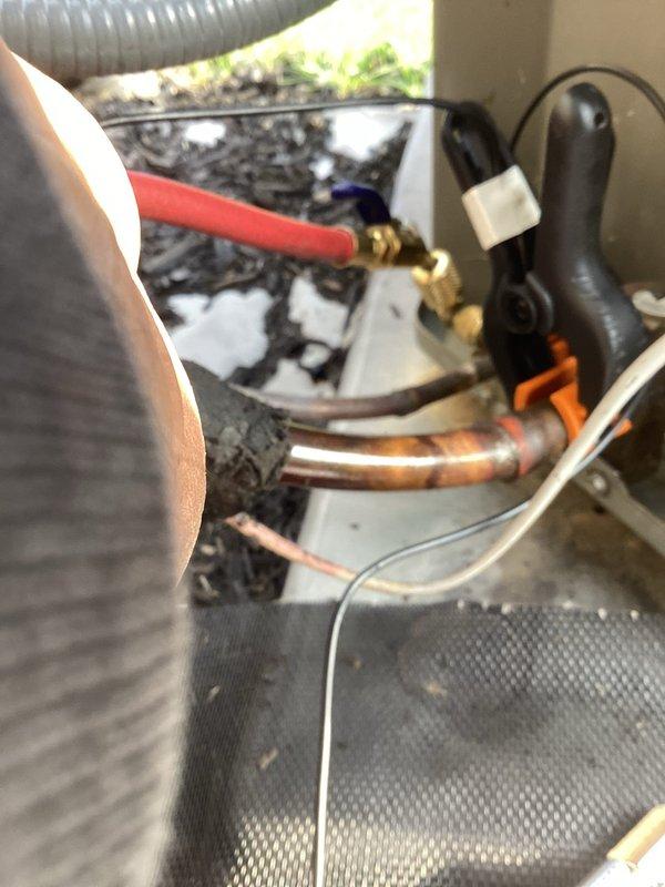 Completed annual cooling maintenance on outdoor AC unit per scheduled service call. Connected manifold gauges to service ports and performed refrigerant pressure diagnostics to verify proper system charge and operation. Inspected refrigerant line connections, copper piping, valves, and all mechanical components for proper function and potential leaks. All equipment found operating within normal parameters with no issues identified during inspection.