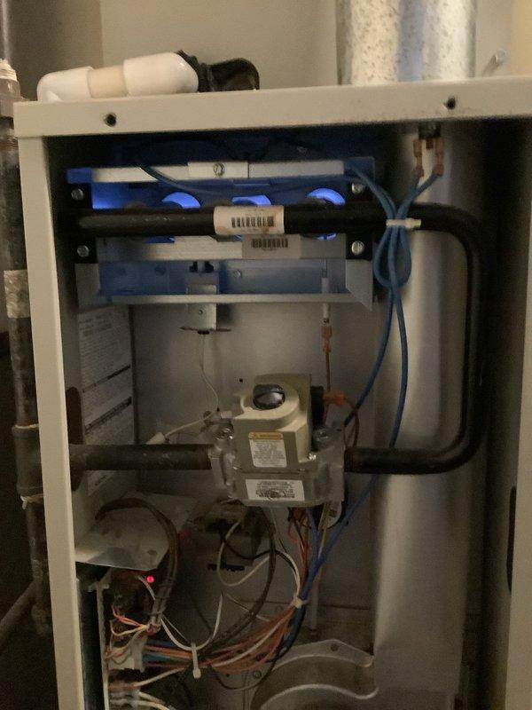 Completed routine maintenance and tune-up on a 7-year-old forced air furnace system. Performed comprehensive system diagnostics using digital multimeter to verify electrical performance and measure amp draw on blower motor, confirming readings within normal operating parameters at 0.285 amps. Inspected internal components including burner assembly, heat exchanger, ignition system, and blower motor. Checked all electrical connections, wire harnesses, and control board for proper operation and secure mounting. Verified gas valve operation and flame sensor functionality. System tested and confirmed operational with no issues identified requiring immediate repair.