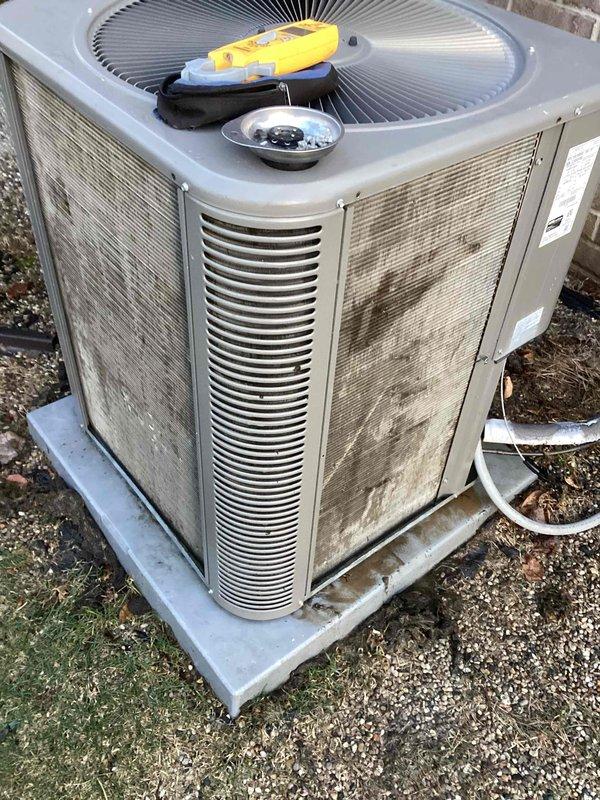 Completed comprehensive AC tune-up on 10-year-old system per annual membership agreement. Inspected outdoor condenser unit, noting significant dust and debris accumulation on coil fins and interior components. Performed standard maintenance procedures including coil cleaning, system diagnostics with testing equipment, and verification of refrigerant lines. System operating properly upon completion with all components functioning within normal parameters.