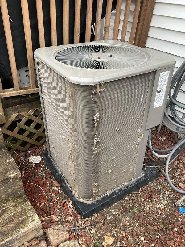 Completed scheduled air conditioning maintenance on outdoor condenser unit. Performed system diagnostics using refrigerant manifold gauge, recording temperature and pressure readings across the system. Replaced air filter and evaporator pad as part of routine maintenance protocol. Unit exhibited significant exterior cabinet deterioration with extensive paint peeling and exposed metal surfaces, though system operational parameters remained within acceptable ranges during testing.