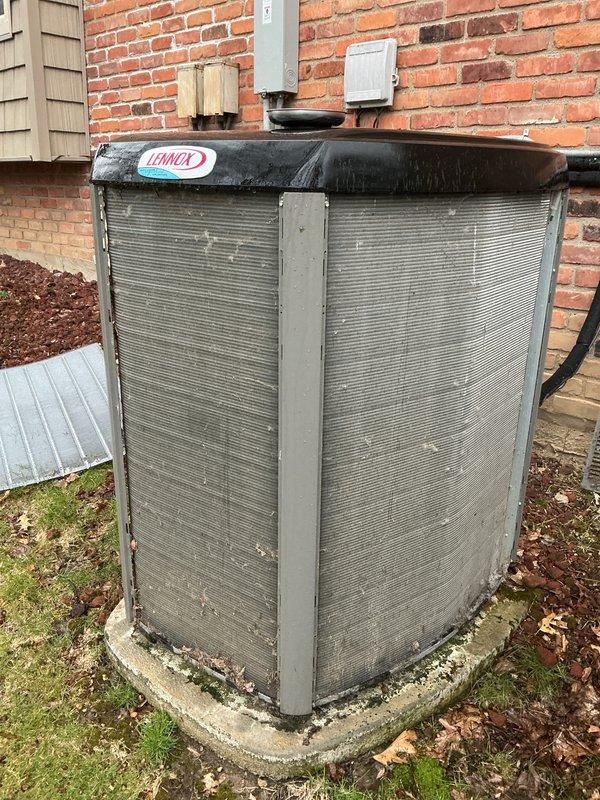 Completed scheduled Air Care Maintenance on two Lennox outdoor condensing units located on exterior concrete pad. Performed comprehensive inspection of both systems, noting significant weathering and surface deterioration on primary unit exterior panels while secondary unit showed better overall condition. Verified refrigerant line connections, electrical conduit integrity, and proper mounting on concrete pad. Documented equipment condition with photographic evidence for maintenance records.