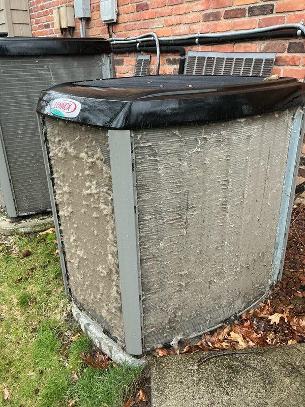 Completed scheduled Air Care Maintenance on two Lennox outdoor condensing units located on exterior concrete pad. Performed comprehensive inspection of both systems, noting significant weathering and surface deterioration on primary unit exterior panels while secondary unit showed better overall condition. Verified refrigerant line connections, electrical conduit integrity, and proper mounting on concrete pad. Documented equipment condition with photographic evidence for maintenance records.