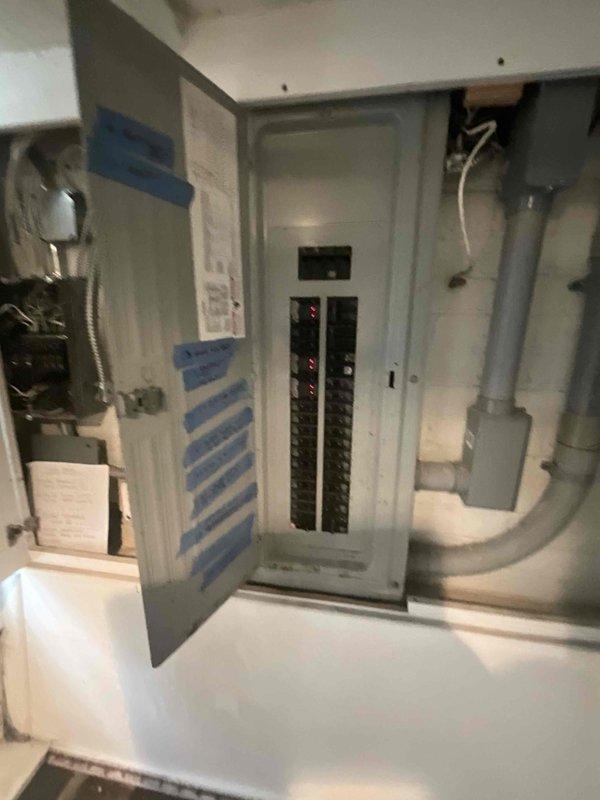 Conducted on-site assessment for new multi-zone mini split installation to provide heating and cooling to 4-6 rooms throughout the residence. Evaluated existing electrical infrastructure, including main panel capacity and available breaker spaces in utility room, to determine compatibility and requirements for new system installation. Documented current electrical configuration and photographed panel layout to develop comprehensive installation plan and ensure proper power supply for multi-head ductless system.