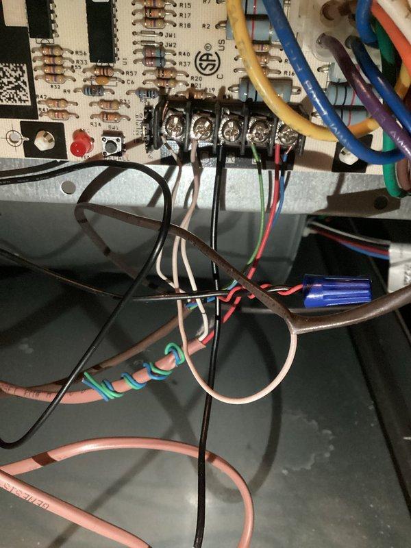 Completed violation repair callback on 3-ton AC system in basement of 1950s-built residence. Installed SAFE-T-SWITCH secondary float switch in auxiliary condensate drain line per code requirements, connecting to existing PVC drain piping and copper line configuration. Verified proper operation of safety switch and confirmed wiring connections to control board terminal block, ensuring system shutdown protection in the event of drain line blockage.