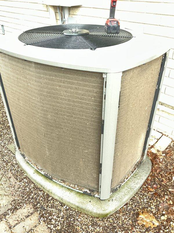 Completed annual cooling maintenance on outdoor condensing unit. Performed standard ACM procedures including inspection of cabinet, fan assembly, and refrigerant lines. Unit operational with fan guard secure and refrigerant line insulation intact. Noted minor weathering on cabinet exterior and algae growth on concrete pad, both typical for outdoor installation age. Condenser coil fins remain in good condition with adequate airflow through side panels.